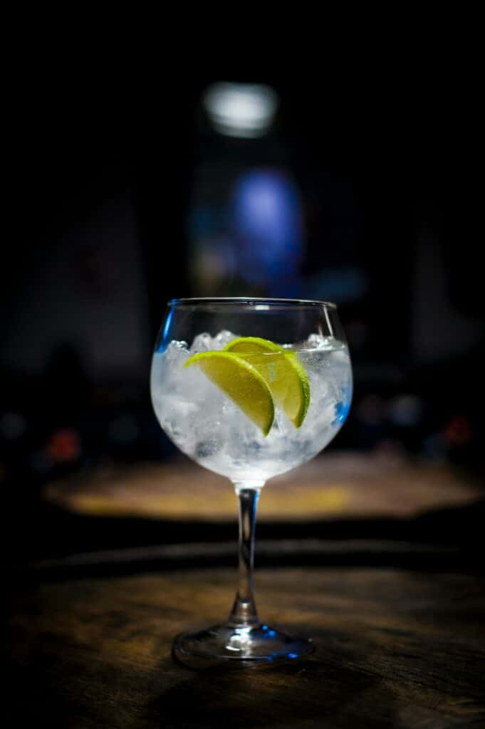 gin and tonic against a dark background